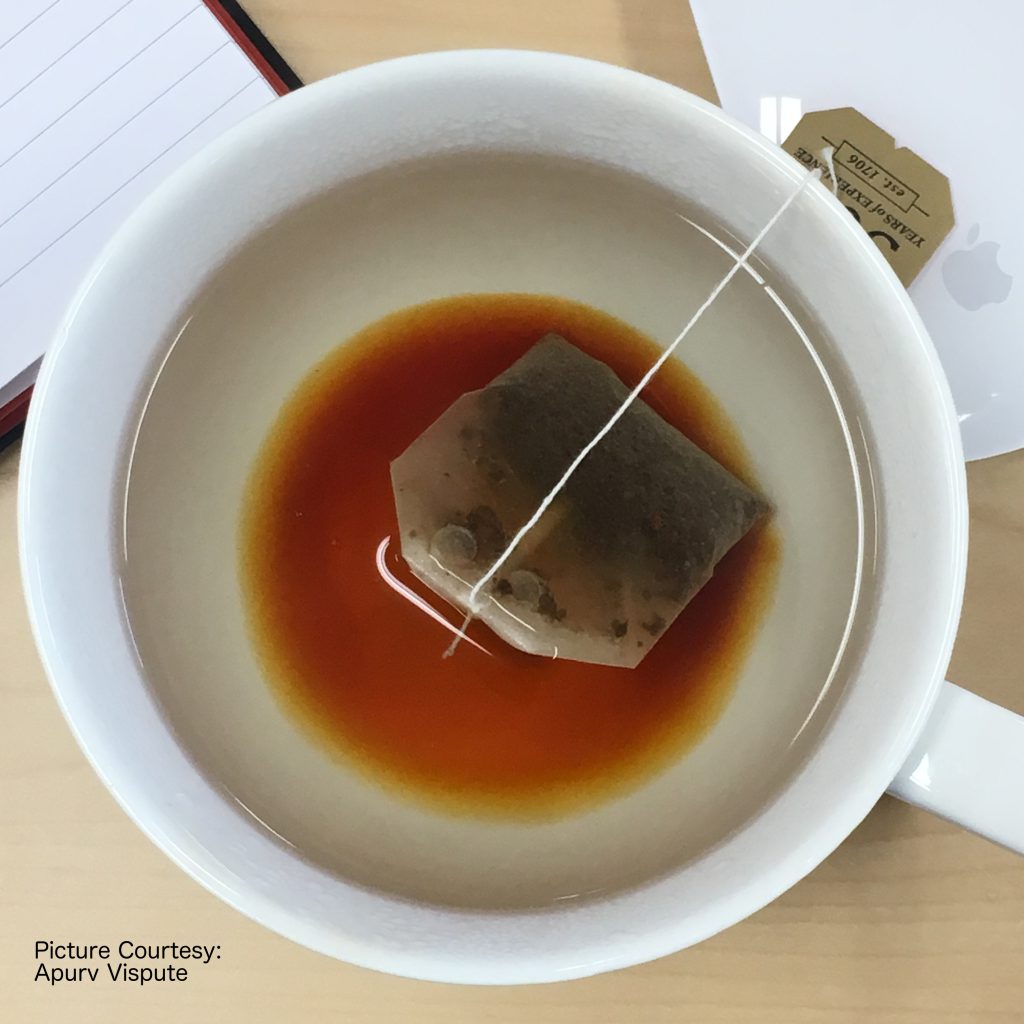 Tea bag steeping in a white cup